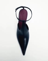 Top-down view of a Magda Butrym black pointed-toe leather pump with an ankle strap and burgundy insole on a white background.