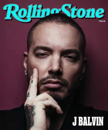 Close-up portrait of musician J Balvin for Rolling Stone Italia, featuring a mauve background, visible tattoos, and a contemplative pose.