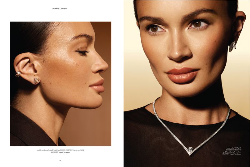 Close-up of a brunette woman with a neutral expression wearing diamond jewelry including ear cuffs and a V-neck necklace.
