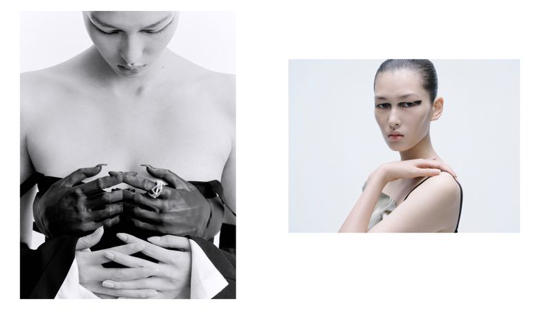 Monochrome studio shot featuring two adult women with slicked-back hair and minimal makeup, one wearing a statement ring.
