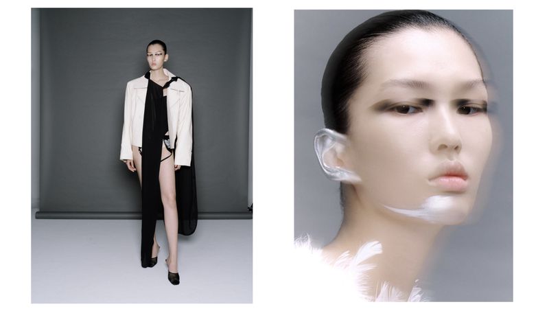 A slender woman with makeup poses in an off-white jacket, a black dress with a slit, and heels on a grey studio background. Close-up of a woman with silver ear and white paint.