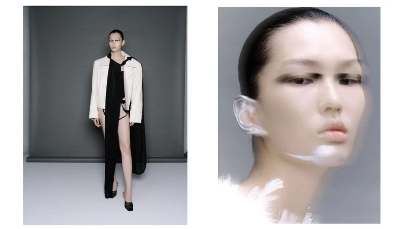 A slender woman with makeup poses in an off-white jacket, a black dress with a slit, and heels on a grey studio background. Close-up of a woman with silver ear and white paint.