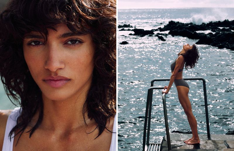 Close-up of an adult female with dark hair and neutral expression. Wide shot of the same woman in swimwear posing near ocean rocks.