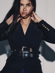 Model Rania Benchegra wearing a black blazer and double belts for Veronica Beard Fall 25 Denim.