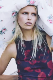 Model Roos Schreiner wearing a floral print top under a large floral head covering for Spaghetti Magazine Breeze
