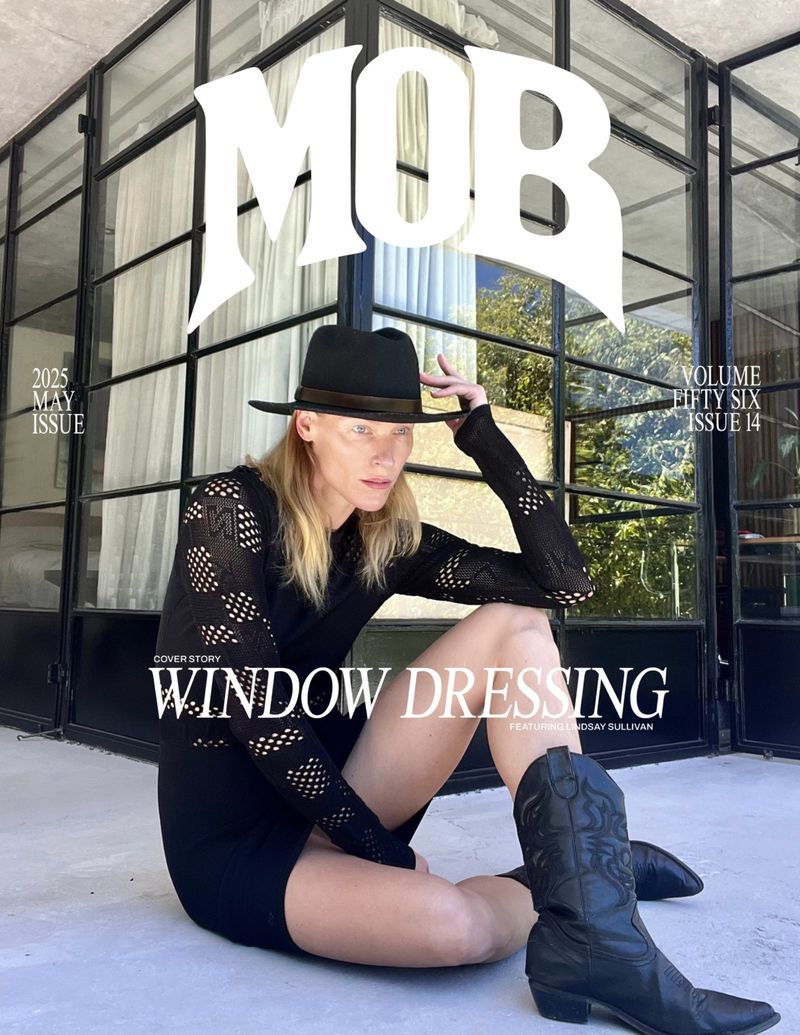 Magazine cover featuring a woman in a black dress, cowboy boots, and hat sitting in front of a window. The title 'MOB' is displayed prominently.