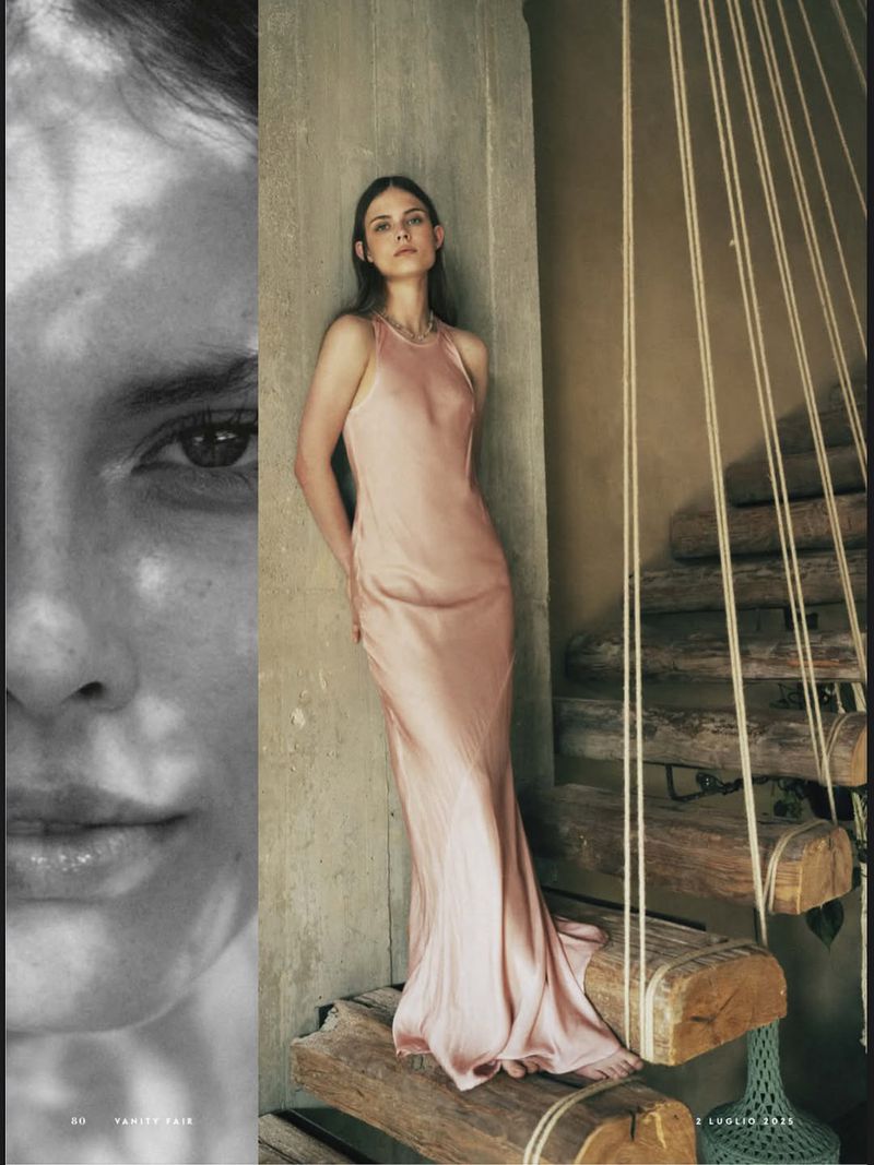 Woman in a pale pink gown posing on a rustic staircase with a partial grayscale portrait on the left, fashion editorial photography.