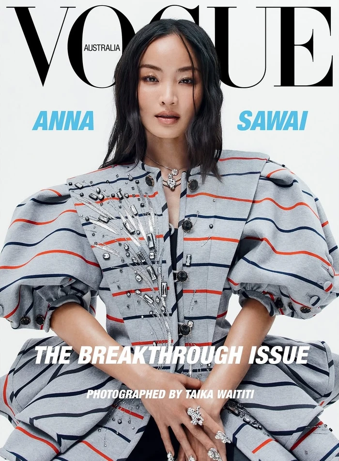 Anna Sawai on the cover of Vogue Australia wearing a structured grey patterned jacket with voluminous sleeves.