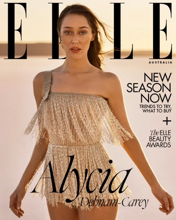 Alycia Debnam-Carey wearing a fringe-detailed playsuit outdoors against a low horizon landscape for Elle Australia.