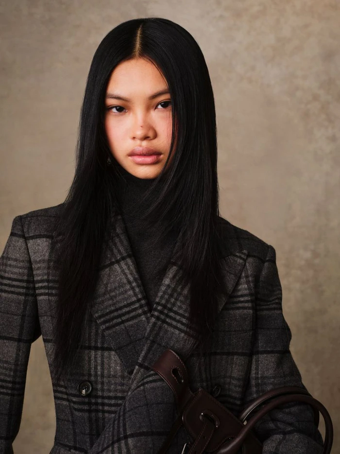 Model Yue Gu with long black hair wearing a grey plaid blazer for Ralph Lauren Collection Fall 2025 shot by Marc Hibbert.