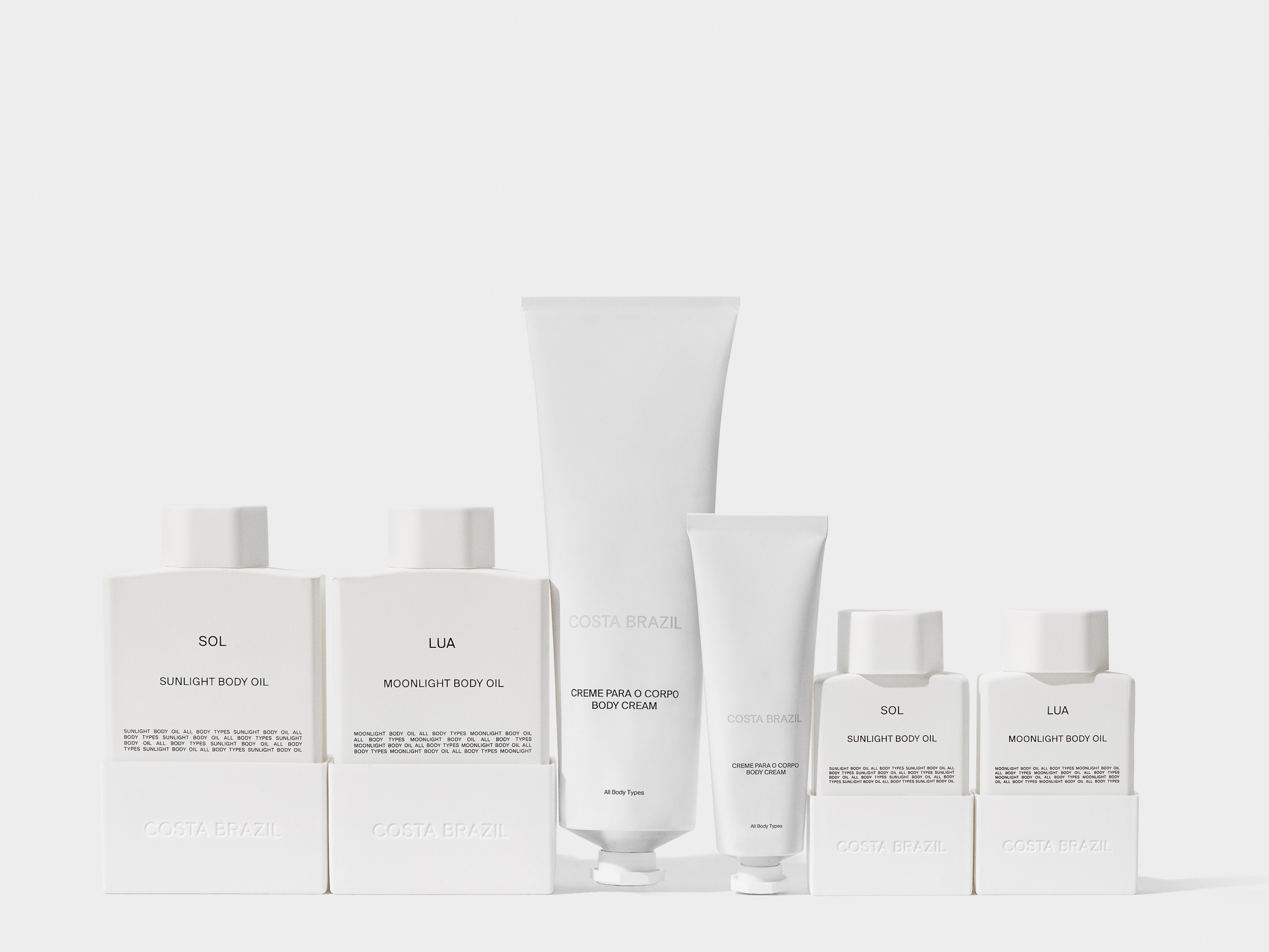 Costa Brazil skincare product line featuring body cream and body oil in simple white packaging, displayed against a neutral background.