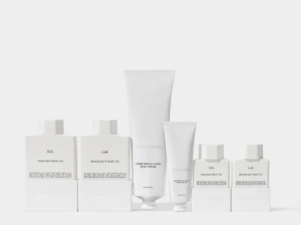 Costa Brazil skincare product line featuring body cream and body oil in simple white packaging, displayed against a neutral background.