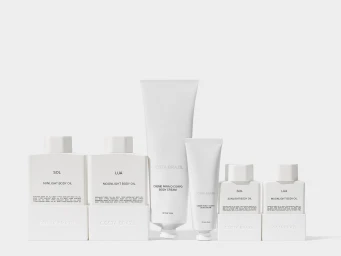 A collection of white Costa Brazil skincare bottles and tubes arranged neatly against a plain white background.