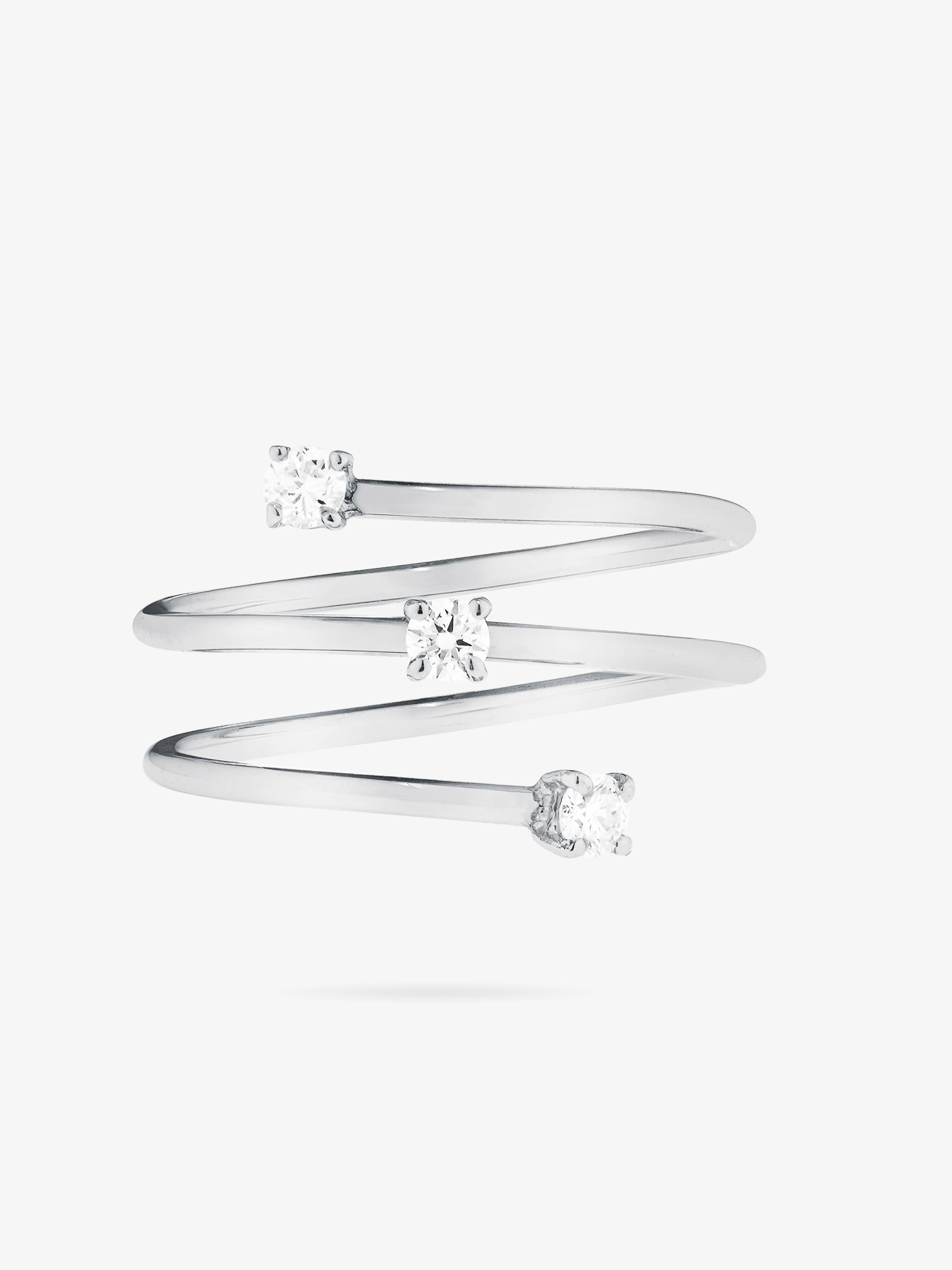 Silver spiral ring with three small, round, clear stones set on a plain white background, showing off the ring's contemporary design.
