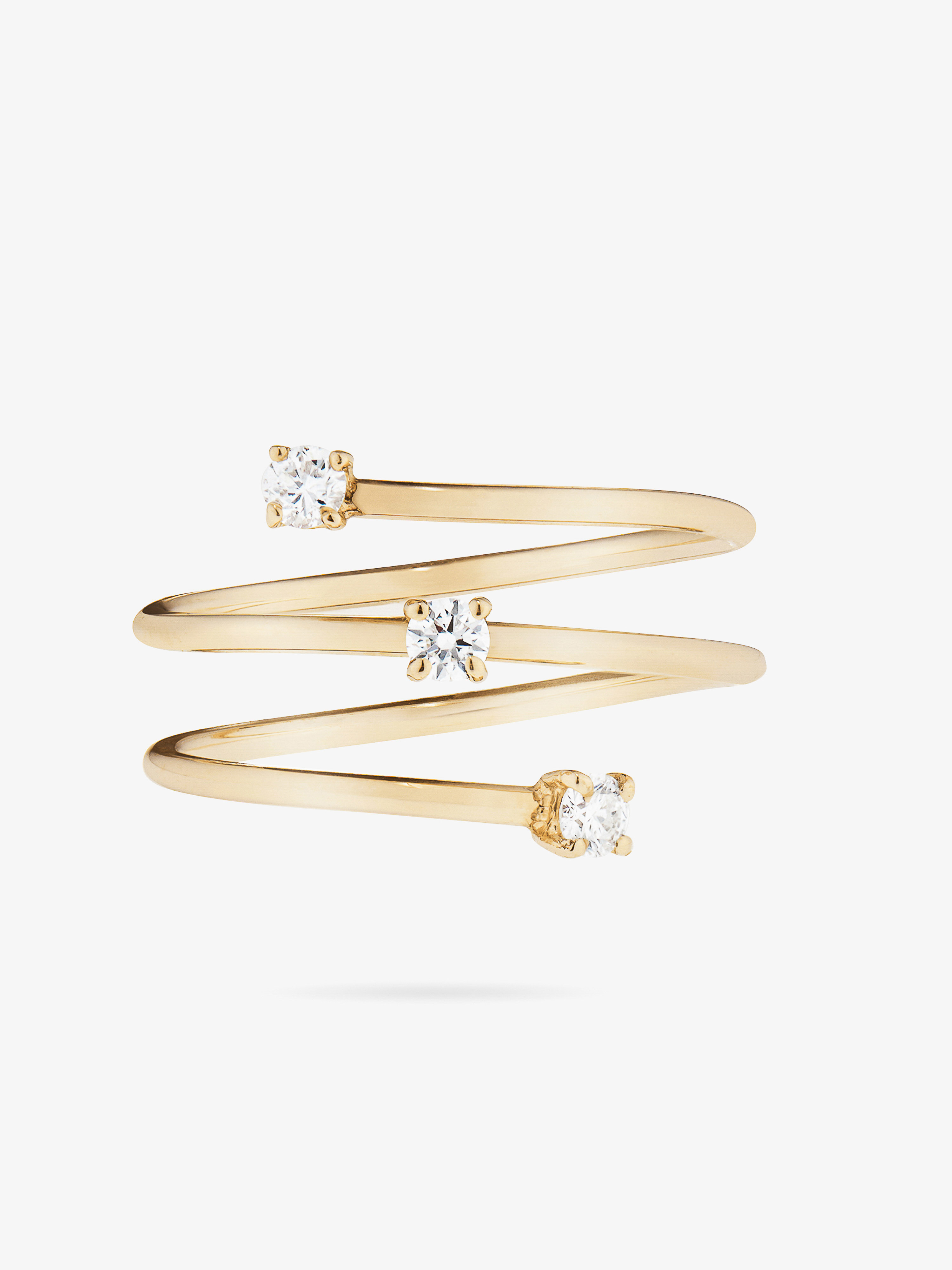 Close-up shot of a spiral ring in gold tone with three small diamonds set on a white background, suitable for jewelry ads.