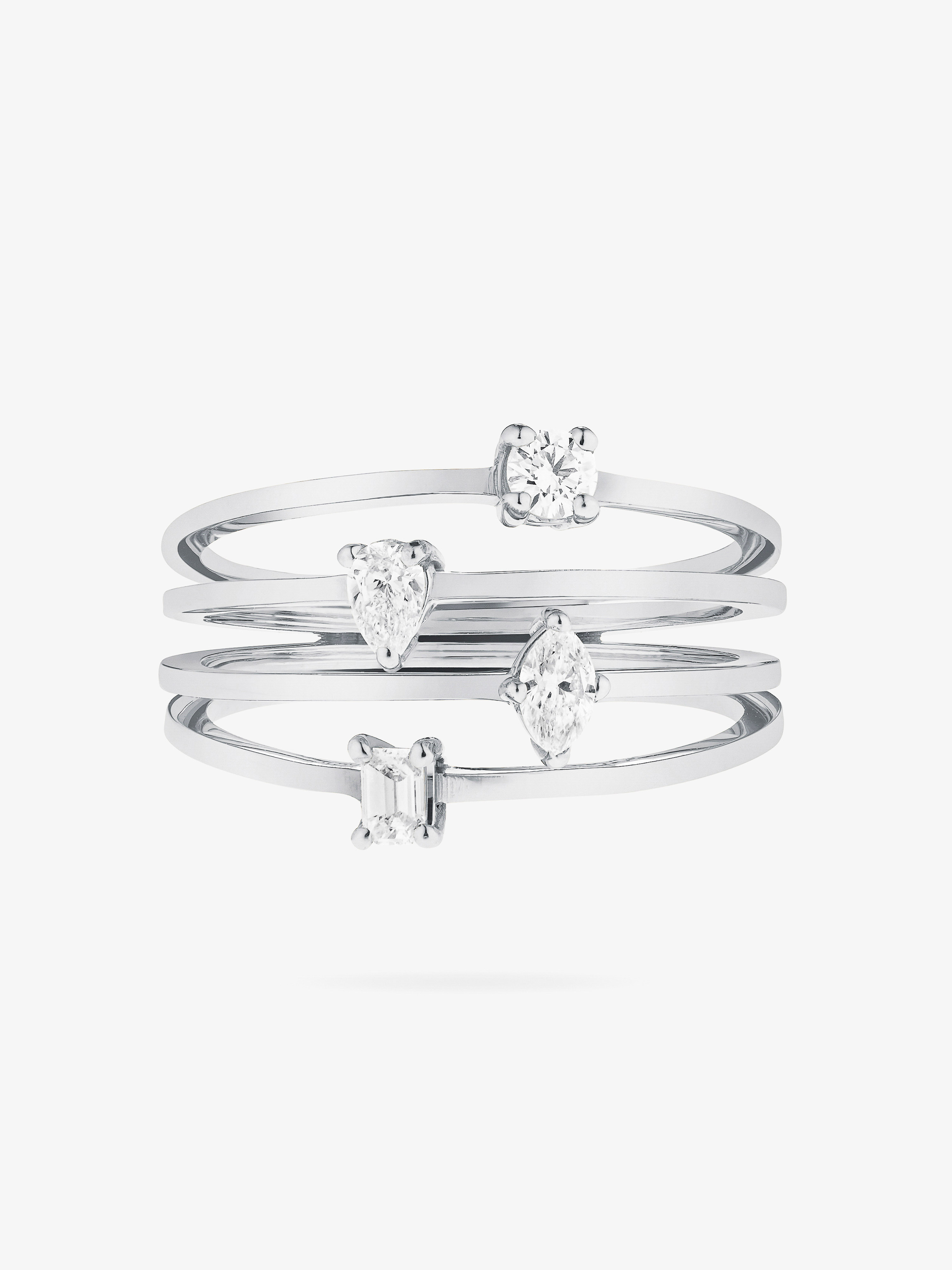 Stacking rings with different diamond cuts sparkle on a white background. These fashion rings are made of polished white metal.