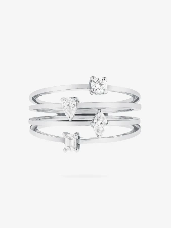 Stacking rings with different diamond cuts sparkle on a white background. These fashion rings are made of polished white metal.