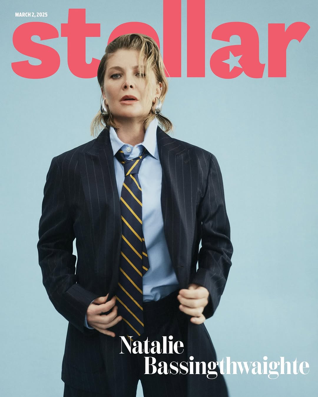 Magazine cover featuring Natalie Bassingthwaighte in a pinstripe suit and tie, set against a pale blue background with 'Stellar' masthead.