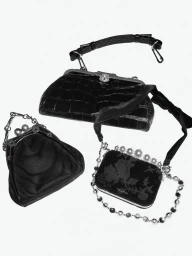 Three black designer handbags arranged on a plain white background for Interview Magazine editorial by Slate Studios