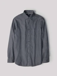Grey button-down long-sleeve shirt laid flat against a neutral light grey seamless background