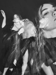 Multiple exposure black and white portrait of a woman in a dark dress creating layered translucent figures against a dark background