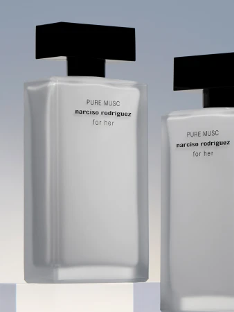 Two rectangular perfume bottles, black caps, minimalist labels, light background. Beauty product shot for fragrance advertising.