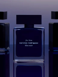 Narciso Rodriguez bleu noir fragrance bottle centered on a reflective surface against a gradient purple and blue background