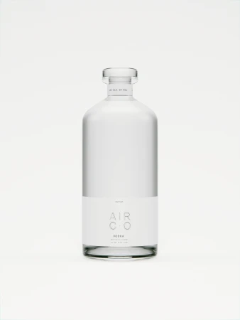 Elegant minimalist studio shot of a clear glass bottle of Air Co vodka with a label, set against a clean, bright white background.
