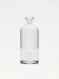 Clear glass vodka bottle with a white label centered against a minimal white background by Slate Studios