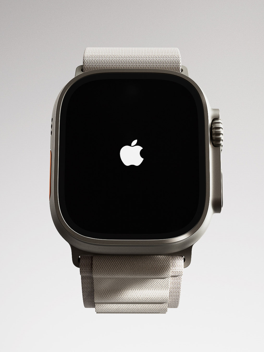 Close-up of an Apple Watch Ultra displaying the Apple logo on a black screen, paired with a neutral-toned fabric band, all against a bright grey backdrop.