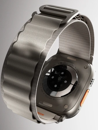 Smartwatch detail with gray woven band and titanium case. Close-up product shot on white showcasing the watch's design.