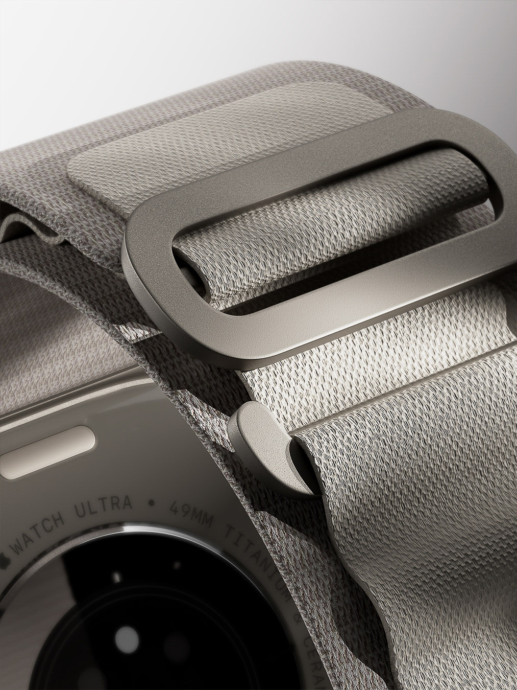 Close-up of an Apple Watch Ultra with a gray woven band, showcasing the device's design and texture on a white background.