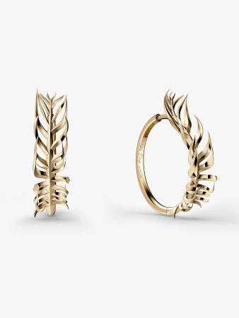 Close-up of two gold hoop earrings with leaf-shaped designs on a white background, showcasing fine jewelry and metalwork.