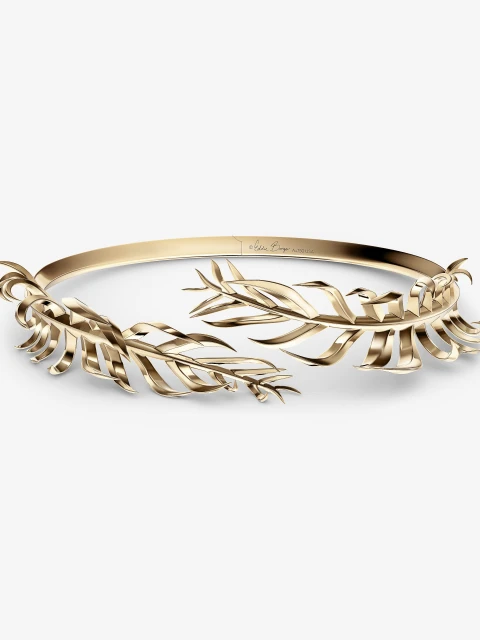 Elegant gold-toned metal headpiece with stylized leaf designs on a white background, perfect for fashion and beauty visuals.