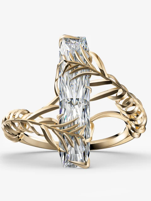Close-up of a gold ring featuring a vertical baguette-cut diamond encircled with leaf-like patterns, set against a white backdrop.