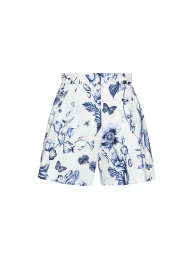 High-waisted white pleated shorts with a blue floral, botanical, and butterfly print against a seamless white background.