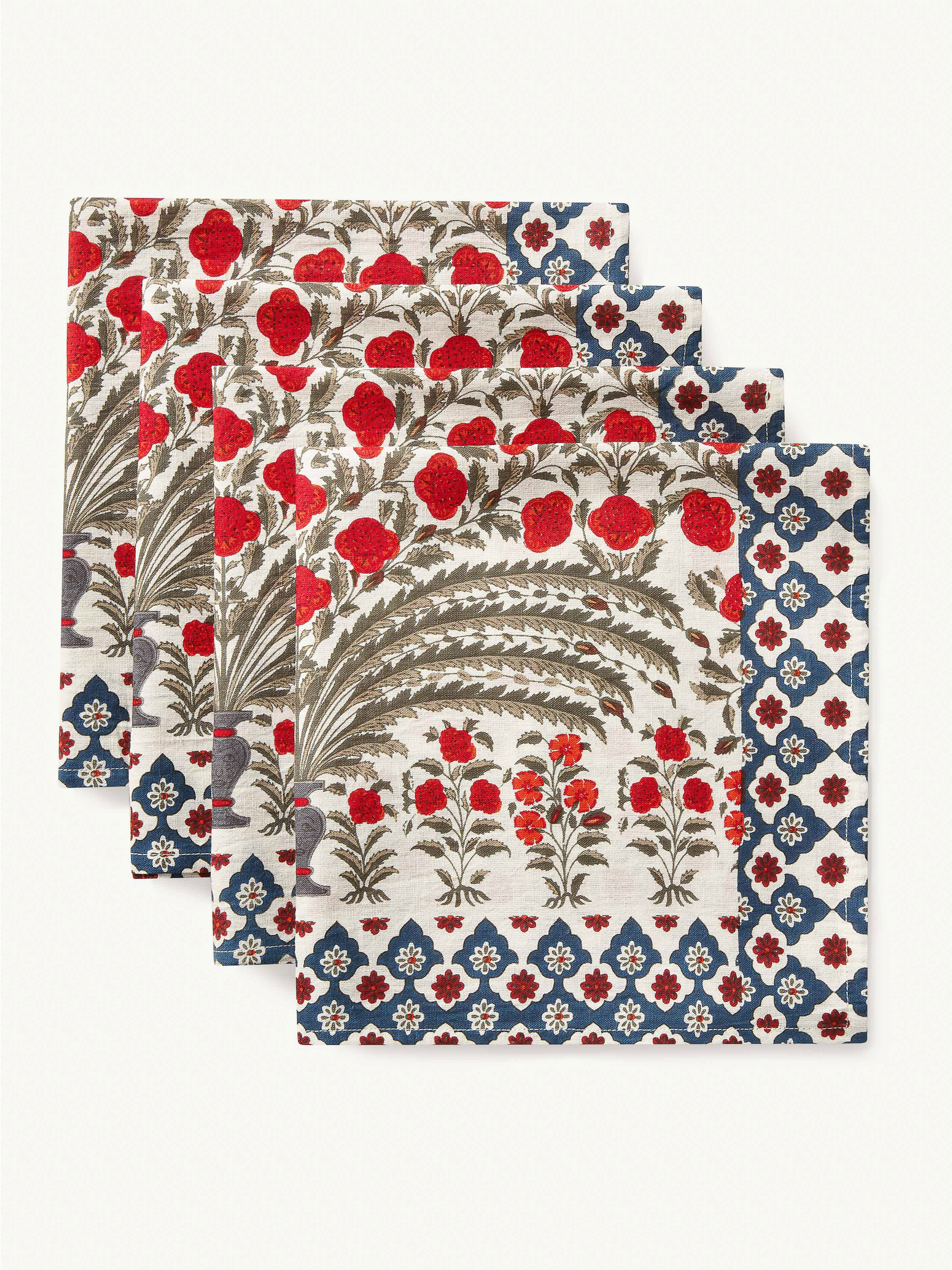 Four white napkins with a red and blue floral design on a white surface, creating a decorative textile product presentation.