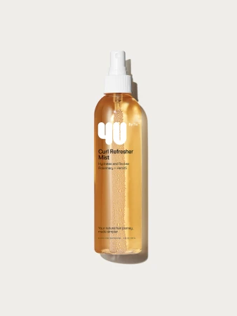 A bottle of 4U by Tia Curl Refresher Mist with a white spray nozzle is displayed on a neutral background in a studio shot.