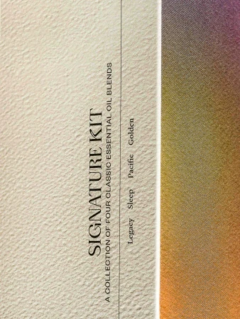Close-up of a Signature Kit box featuring classic essential oil blends. Text on the box includes 'Legacy', 'Sleep', 'Pacific', and 'Golden'.