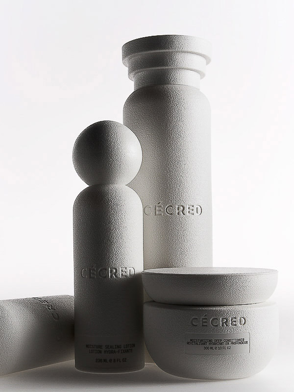 Group of white skincare products including moisturizer and lotion bottles on a white background in a studio setting. Beauty shot.