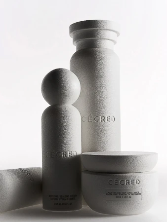 Group of white skincare products including moisturizer and lotion bottles on a white background in a studio setting. Beauty shot.