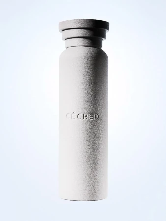 Minimalist bottle with the word 'CECRED' vertically printed. The bottle is gray with a unique top design and a light background.