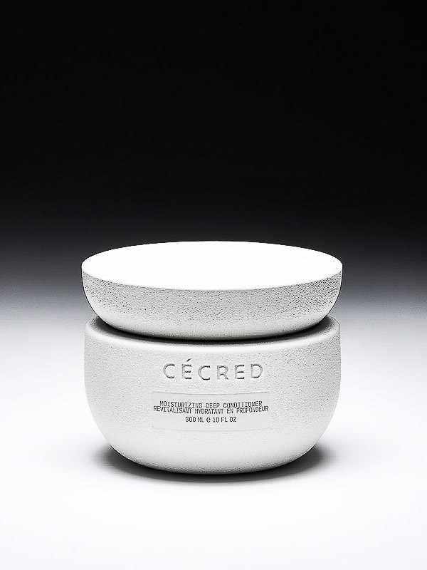 Cécred Moisturizing Deep Conditioner in a white textured jar with a matching lid, set against a gradient black to white background.