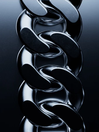 Close-up of a thick, silver chain with multiple links, reflecting light against a dark gray background; showcasing the chain's texture and design.