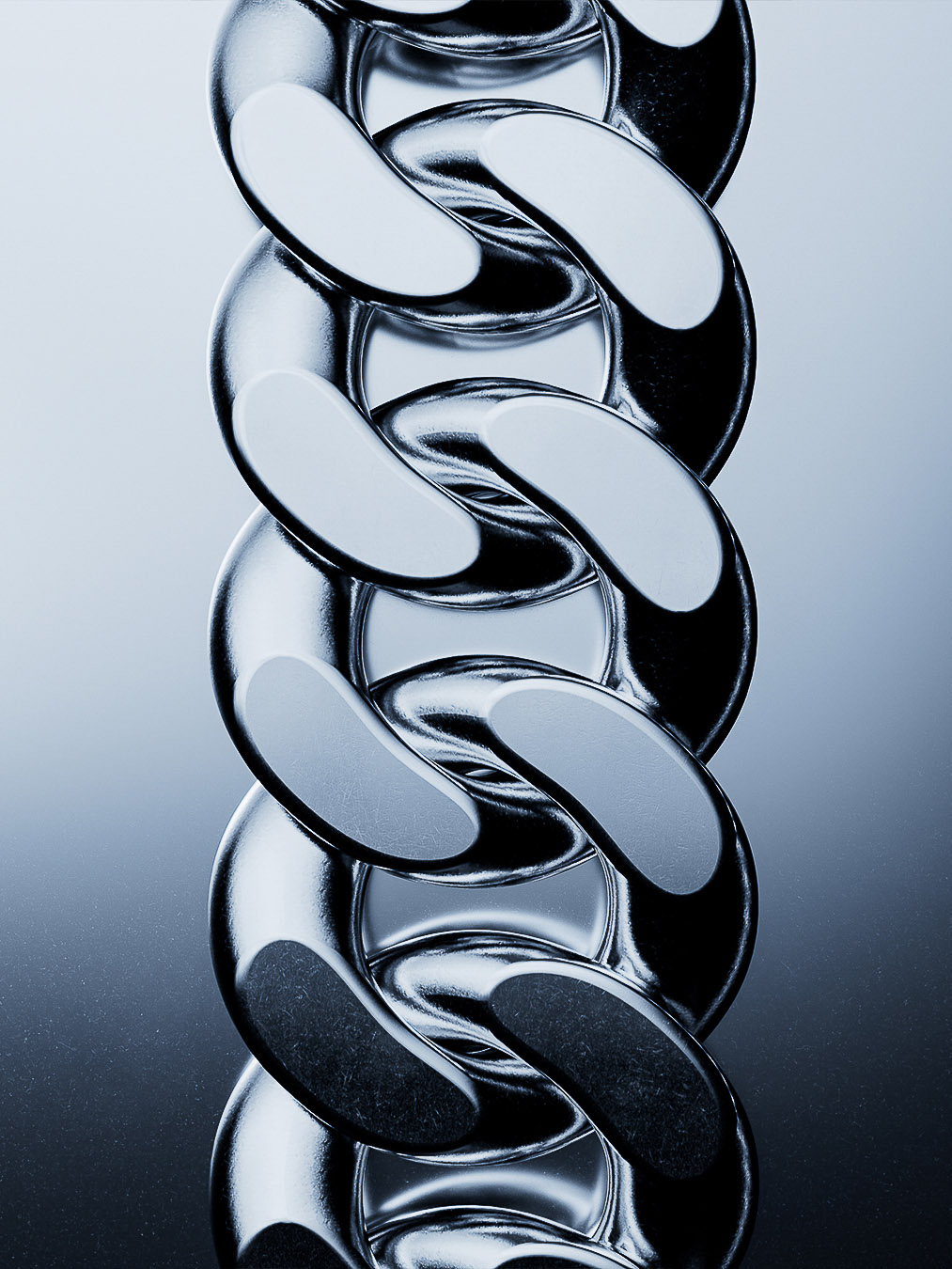 Macro shot of a glossy silver chain with interlocking links, highlighted by studio lighting and a gradient blue background.