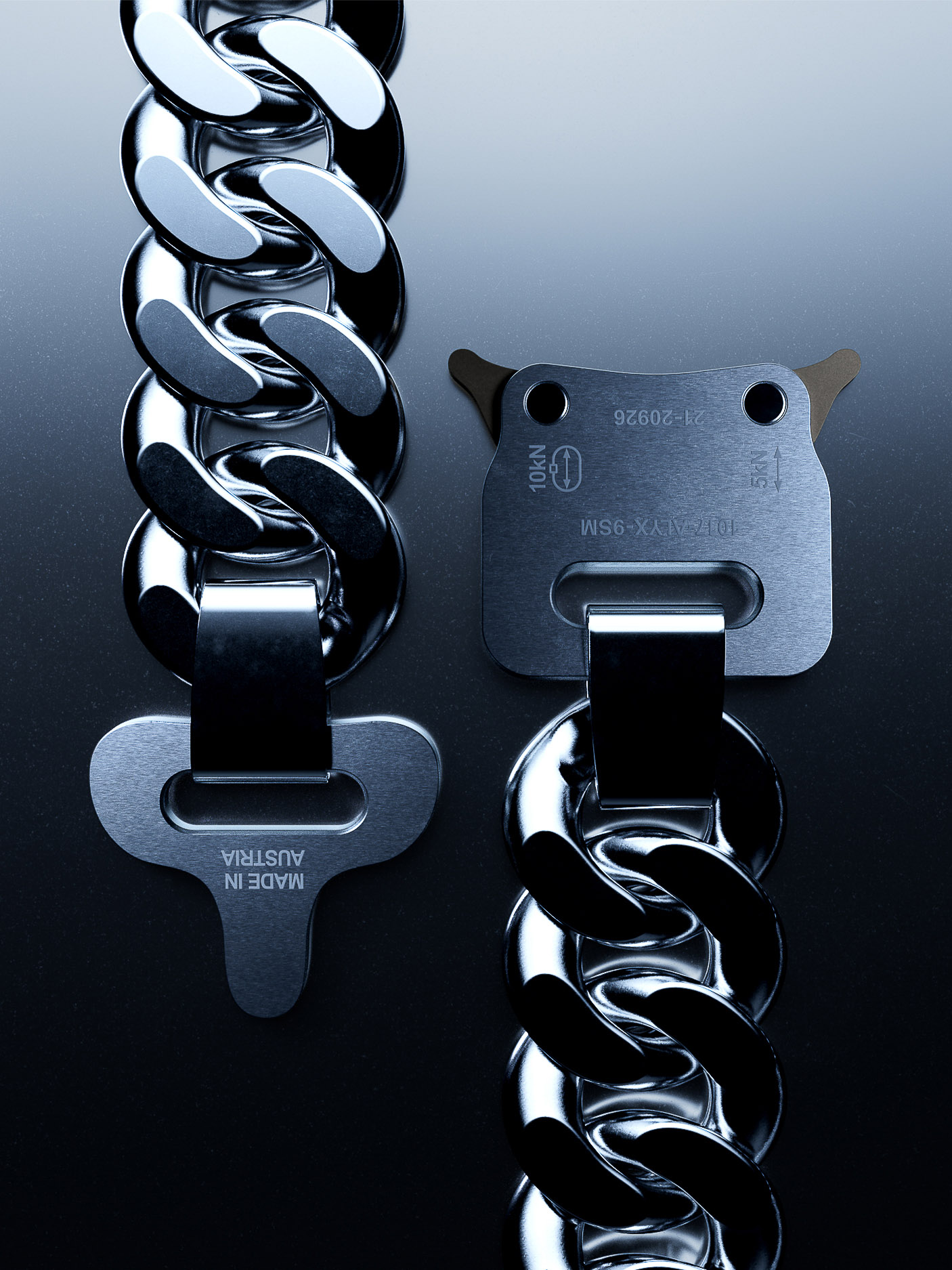 Macro shot of a silver metal chain and buckle with 'Made in Austria' inscription, showcasing industrial-style fashion accessory.