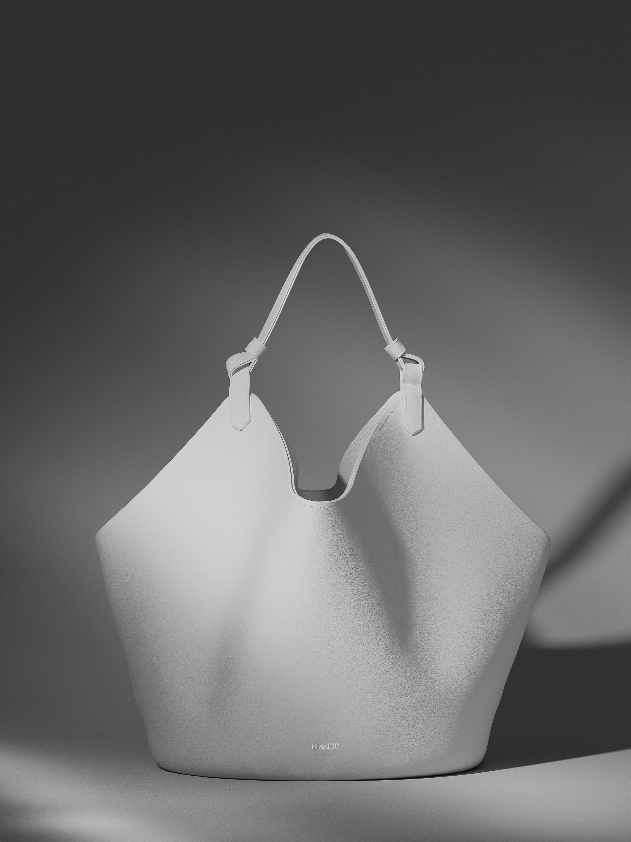 Studio shot of a large, off-white hobo bag with top handle on a neutral gray background, showcasing its design and material.