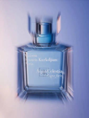 Still life studio shot of a Maison Francis Kurkdjian Aqua Celestia Cologne Forte perfume bottle on a gradient blue background.