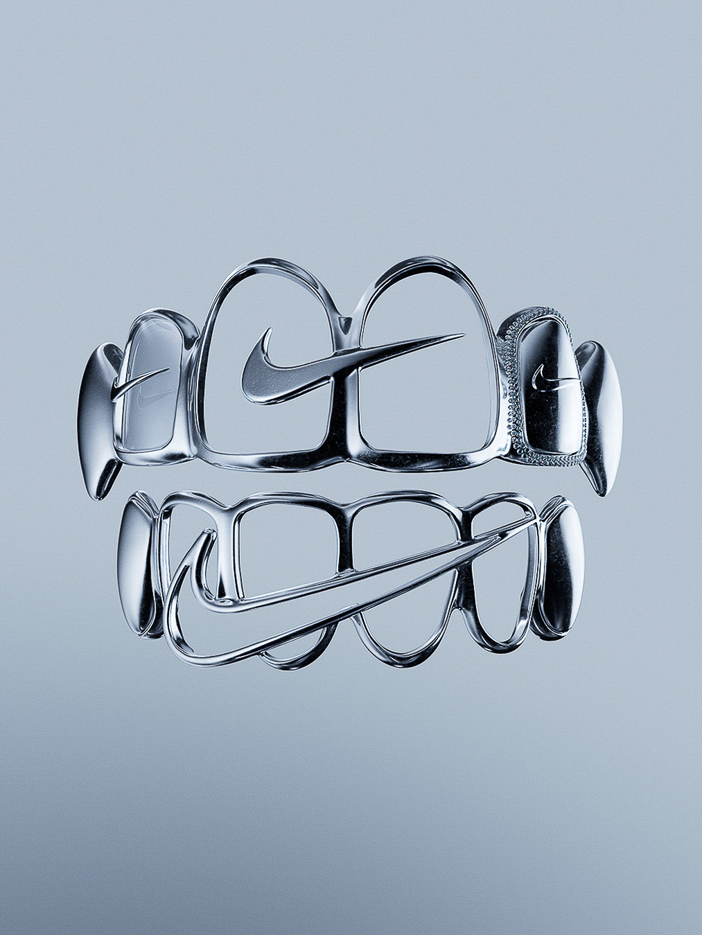 Chrome teeth grills with a Nike logo design; creative dental fashion accessory with silver metallic texture against a grey gradient background.
