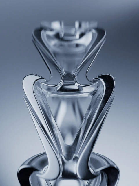 Close-up studio shot of an artful glass vase with a tiered, geometric design in soft lighting, showcasing a modern aesthetic.